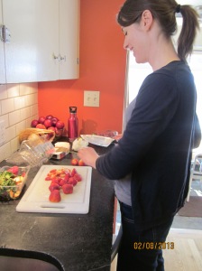 Angie hulling the strawberries