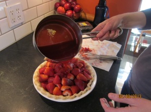 Pouring the gelatin mixure on to the berries