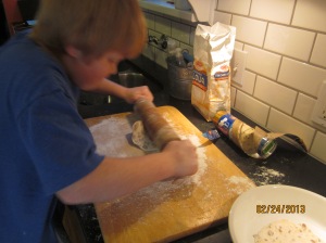 Mom's helper puts some muscle into rolling out the dough